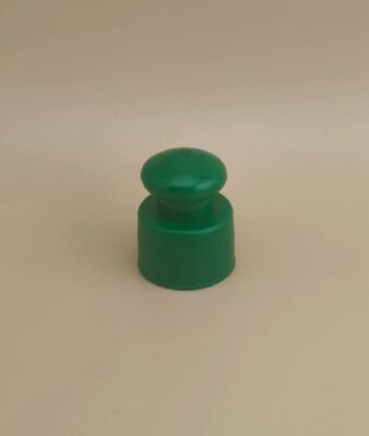Zielona plastikowa gładka zakrętka z przyciskiem do butelek kosmetycznych